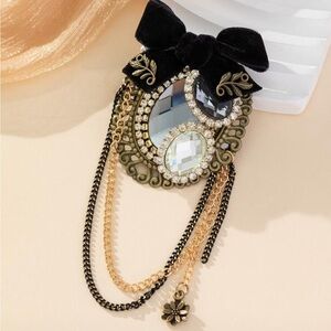 Elegant Black and Gold Brooch with Crystal Accents